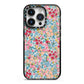 Floral Meadow iPhone 14 Pro Black Impact Case on Silver phone