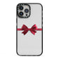 Christmas Bow iPhone 13 Pro Max Black Impact Case on Silver phone