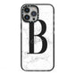 Monogrammed White Marble iPhone 13 Pro Max Black Impact Case on Silver phone