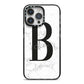 Monogrammed White Marble iPhone 14 Pro Max Black Impact Case on Silver phone