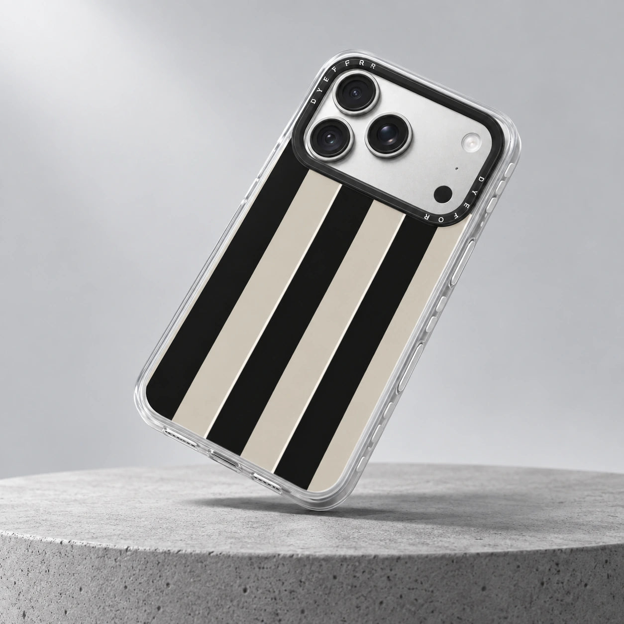 Illustrative drop scene featuring a Studio Stripe case landing corner-first on a concrete plinth